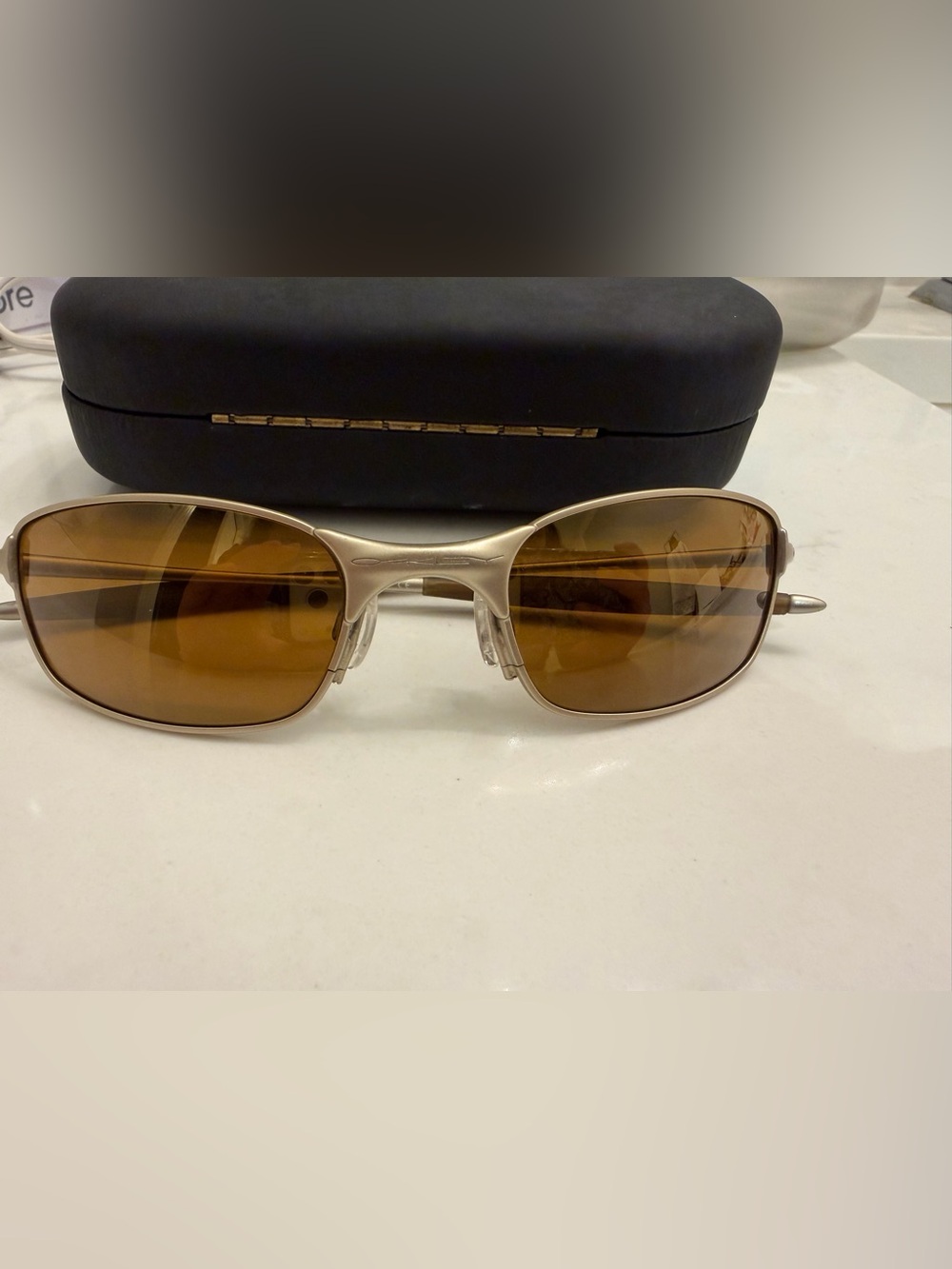 Oakley Silver Titanium-Style Sunglasses with Brown Lenses